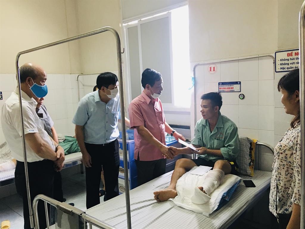 Chủ tịch Công đoàn Đường sắt Việt Nam (áo hồng) Mai Thành Phương trao hỗ trợ cho anh Nguyễn Văn Thành – công nhân Cung cầu Việt Trì tại Bệnh viện đa khoa tỉnh Phú Thọ. Ảnh: Trần Kiên