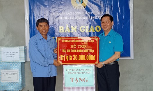 Phó Chủ tịch Liên đoàn Lao động Hà Nội Phạm Bá Vĩnh trao 30 triệu đồng và quà cho đoàn viên khó khăn Hà Văn Thanh. Ảnh: Ngọc Ánh