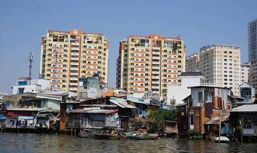 Bện cạnh những khu nhà ổ chuột ở kênh Đôi (quận 8), rất nhiều công trình, khu nhà cao tầng dân mọc lên.  Ảnh: Minh Quân
