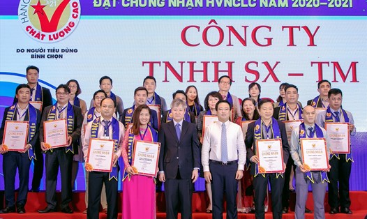 Đại diện Tổng công ty Khánh Việt (đứng ngoài cùng hàng thứ 2 bìa phải) nhận chứng nhận Hàng Việt Nam chất lượng cao. Ảnh: Thành Tuyến
