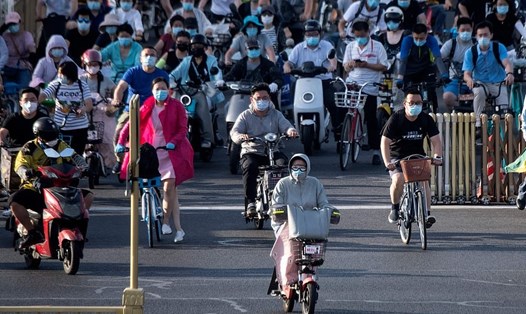 Làn sóng dịch mới bùng phát ở Bắc Kinh từ chợ thực phẩm Tân Phát Địa. Trong ảnh là người dân Bắc Kinh đeo khẩu trang khi di chuyển trong giờ cao điểm ở Bắc Kinh. Ảnh: AFP.