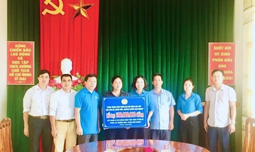 Đại diện LĐLĐ huyện Sơn Dương trao tiền hỗ trợ xây dựng công trình chào mừng Đại hội Đảng các cấp. Ảnh: Thu Loan.