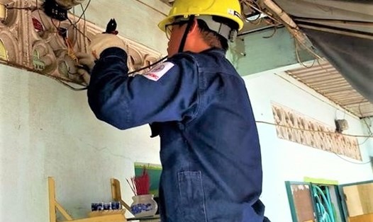 Thanh niên công nhân EVNHCMC sửa điện cho Khu nhà trọ công nhân ở huyện Bình Chánh, TPHCM. Ảnh Đức Long