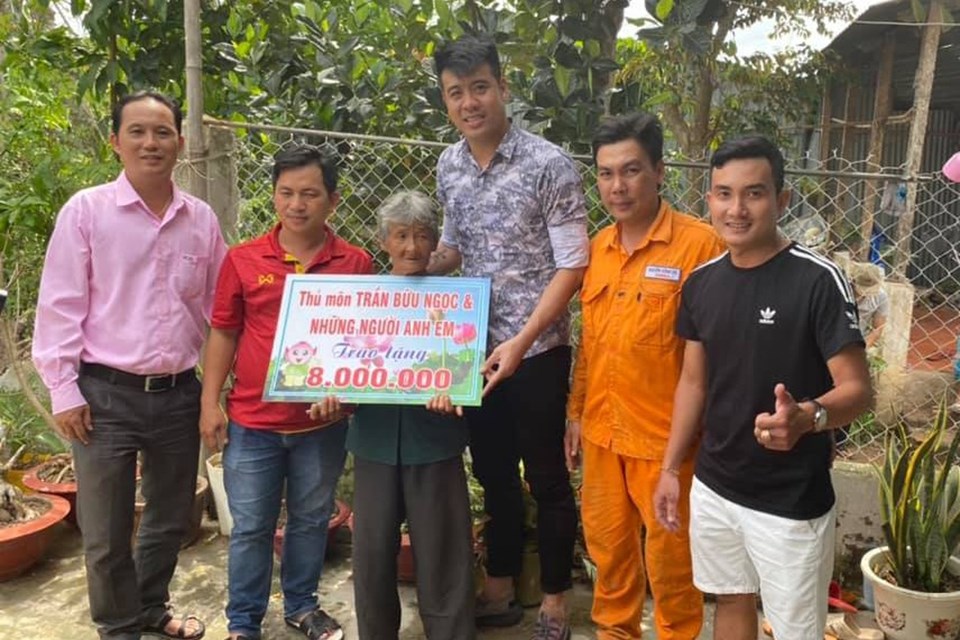 Thủ môn Trần Bửu Ngọc (giữa) trao tặng số tiền anh quyên góp được cho cụ bà Nguyễn Thị Hái. Ảnh: NVCC Thủ môn Trần Bửu Ngọc (giữa) trao tặng số tiền anh quyên góp được cho cụ bà Nguyễn Thị Hái. Ảnh: NVCC