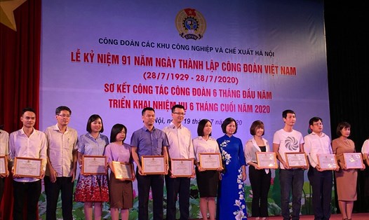 Chủ tịch Liên đoàn Lao động Hà Nội Bùi Huyền Mai (áo dài xanh) tặng Giấy khen cho các tập thể. Ảnh: Hải Anh