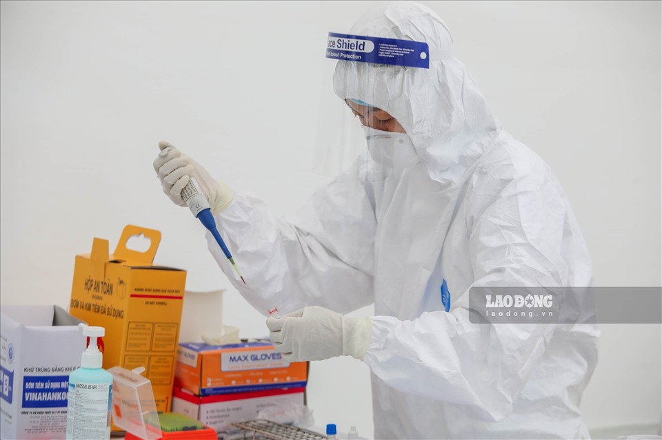 Cán bộ y tế lấy mẫu xét nghiệm COVID-19. Ảnh: Lao Động