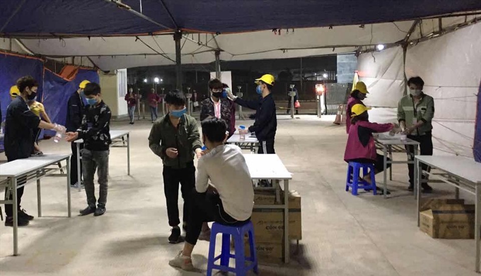 Công nhân lao động Công ty TNHH Newwing Interconnect Technology (Bắc Giang) được khử khuẩn trước khi vào làm việc trong xưởng. Ảnh: Bảo Hân.