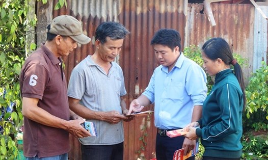 Chính quyền xã Ea Hu, huyện Cư Kuin, tỉnh Đắk Lắk phát tờ rơi tuyên tuyền cho người dân về nguy hiểm của bệnh sốt xuất huyết. Ảnh: Nam Trang