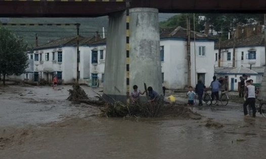 Người dân cố gắng dọn dẹp thiệt hại do lũ lụt gây ra dưới một cây cầu ở thành phố Rajin, Triều Tiên vào mùa mưa 2015. Ảnh: Reuters