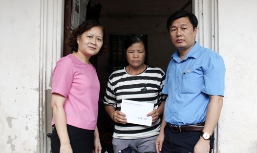 Bà Nguyễn Thanh Thủy (bên trái) và đại diện LĐLĐ huyện trao hỗ trợ cho gia đình nạn nhân. Ảnh: Nguyễn Anh Quân