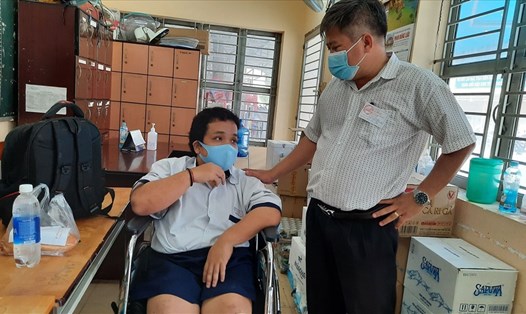 Thí sinh Nguyễn Văn Tâm (trái) được thầy giáo đẩy vào phòng nghỉ ngơi sau khi kết thúc môn thi Ngữ văn. Ảnh: Cộng tác viên