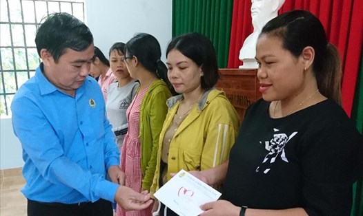 Chủ tịch LĐLĐ tỉnh Quảng Nam Phan Xuân Quang trao quà hỗ trợ cho đoàn viên bị ảnh hưởng bão số 5. Ảnh: Phương Nguyên