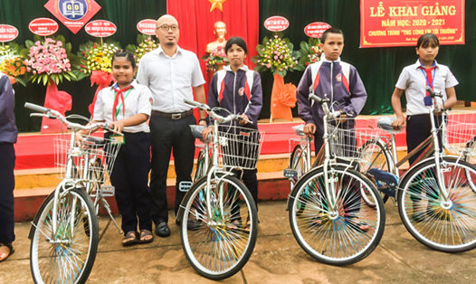 Ông Trần Duy Thăng Long, đại diện Tập đoàn TNG Holdings Vietnam trao tặng xe đạp cho các học sinh nghèo vượt khó