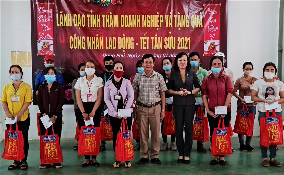 Bà Huỳnh Thị Hằng (hàng đầu tiên, thứ 3 từ phải qua) thăm, tặng quà tết cho công nhân lao động ở doanh nghiệp. Ảnh: Văn Sơn