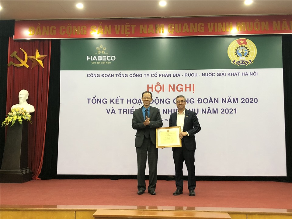Ông Vũ Trường Sơn - Phó Chủ tịch Công đoàn Công thương Việt Nam (bên trái) trao Bằng khen của Tổng LĐLĐVN cho ông Phạm Việt Dũng - Chủ tịch Công đoàn TCty Cổ phần Bia - Rượu - Nước giải khát Hà Nội. Ảnh: Hà Anh