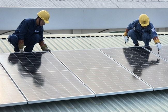 Các thanh niên công nhân của EVNHCMC lắp đặt, trao tặng công trình điện mặt trời mái nhà cho “Mái ấm Quận Tân Bình". Ảnh Nam Dương