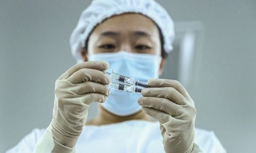 Nhân viên kiểm tra ống kiêm sản phẩm vaccine COVID-19 bất hoạt tại một nhà máy đóng gói của công ty trực thuộc Sinopharm, ở Bắc Kinh, Trung Quốc. Ảnh: Tân Hoa Xã