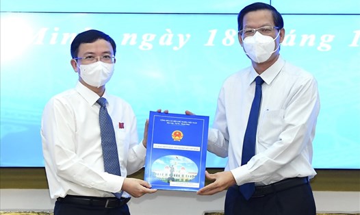 Chủ tịch UBND TPHCM Phan Văn Mãi (bìa phải) trao quyết định bổ nhiệm cho ông Đặng Quốc Toàn. Ảnh: VIỆT DŨNG