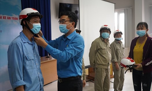 Lãnh đạo Công đoàn ngành Công Thương Hải Phòng trao mũ bảo hiểm tặng 50 công nhân Công ty CP Điện cơ. Ảnh: Mai Dung