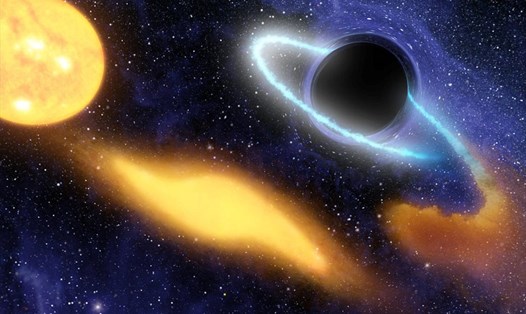 Ảnh minh họa cho thấy một hố đen siêu lớn ở trung tâm của một thiên hà xa xôi đang nuốt chửng tàn dư của một ngôi sao. Ảnh: NASA/JPL-Caltech