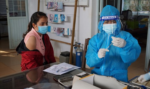 Nhân viên y tế tỉnh Kon Tum test nhanh COVID-19, tiêm vaccine cho người dân. Ảnh T.T