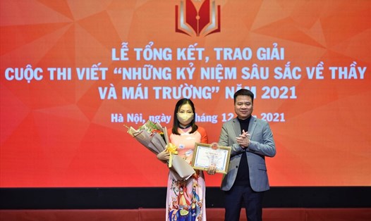 Ông Triệu Ngọc Lâm – Tổng Biên tập Báo Giáo dục và Thời đại trao giải Nhất cho cô giáo Lê Hải Vân.