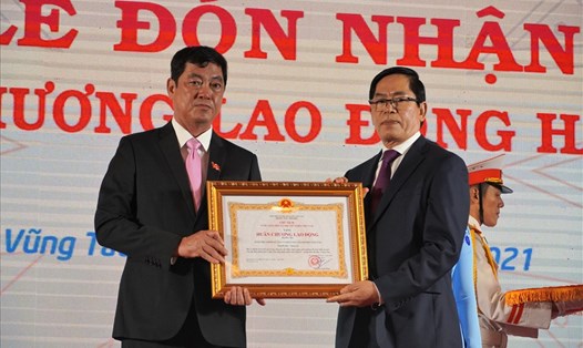 Ông Trần Đình Khoa - Bí thư Thành ủy TP.Vũng Tàu (trái) đại diện Đảng bộ, Chính quyền địa phương đón nhận Huân chương Lao động hạng Ba. Ảnh: T.A