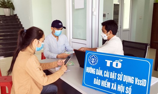 Bảo hiểm xã hội huyện Phú Ninh hướng dẫn người dân làm thủ tục nhận hỗ trợ từ Quỹ BHTN. Ảnh: Hải Châu