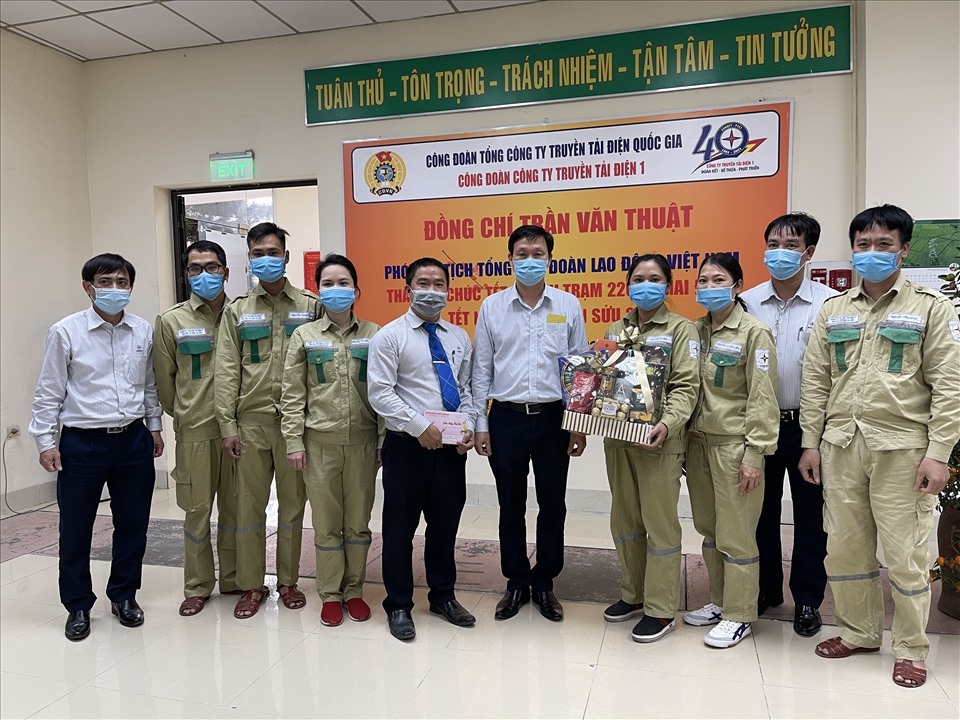 Chủ tịch Công đoàn Tổng Công ty Truyền tải điện Quốc gia Trịnh Tuấn Sơn (thứ 6 từ trái sang) tặng quà cán bộ, công nhân viên Trạm 220kV Mai Động. Ảnh: Hà Anh