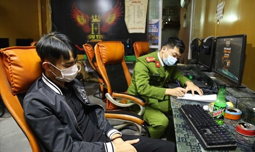Công an lập biên bản đối với nhóm thanh niên vi phạm quy định phòng dịch COVID-19 ở thị xã Đông Triều, Quảng Ninh. Ảnh: CTV
