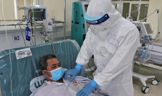 ThS.BS Vương Xuân Toàn (Khoa Hồi sức tích cực, Bệnh viện Bạch Mai) kiểm tra tình hình sức khỏe cho bệnh nhân COVID-19 trong phòng ICU (chăm sóc tích cực). Ảnh: Bộ Y tế cung cấp