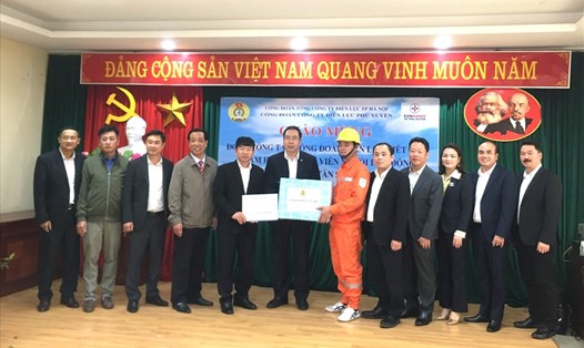 Ông Đỗ Đức Hùng - Chủ tịch Công đoàn Điện lực Việt Nam (thứ 6, từ trái sang) tặng quà nhân viên điện lực Hà Nội. Ảnh: Vân Anh