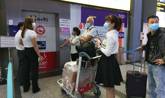 Hành khách chờ đợi trước thang máy trong nhà xe TCP sân bay Tân Sơn Nhất để đón xe công nghệ. Ảnh: Minh Quân
