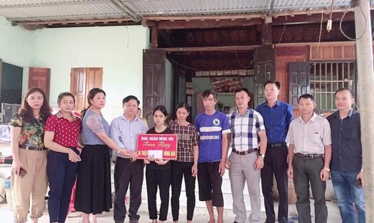 Cô giáo Nguyễn Thị Xuân - Hiệu trưởng trường THCS Hạnh Thiết (Quỳ Châu, Nghệ An) trao tặng  30 triệu đồng của ông Đoàn Ngọc Hải cho gia đình em Tuấn. Ảnh: Quang Minh