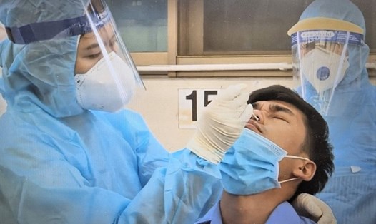 Nhân viên Trung tâm Kiểm soát bệnh tật TPHCM lấy mẫu ngẫu nhiên để xét nghiệm cho công nhân Cty Việt Nam Paiho. Ảnh: Đức Long
