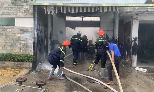 Lực lượng PCCC đang phun nước vào xưởng bị cháy. Ảnh: Phạm Duy