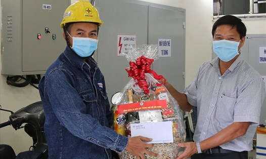 Ông Lê Văn Minh (bên phải) – Chủ tịch Công đoàn EVNHCMC thăm hỏi, động viên công nhân trực vận hành đảm bảo cung cấp điện trong thời gian giãn cách phòng chống dịch COVID-19 trên địa bàn quận 1. Ảnh Đức Long