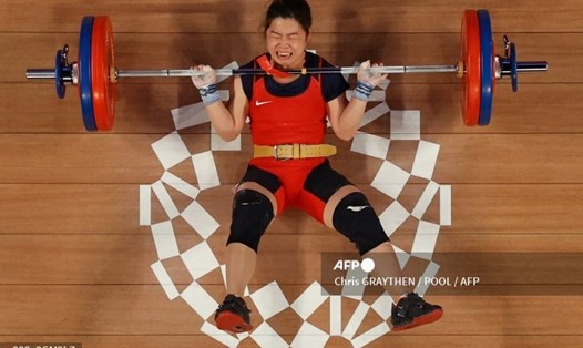 Hoàng Thị Duyên té ngã ở phần thi cử đẩy môn cử tạ hạng cân 59kg nữ Olympic Tokyo 2020. Ảnh: AFP.