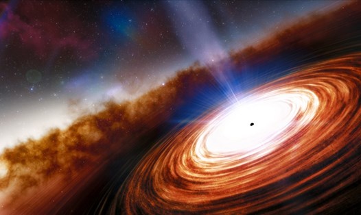 Hố đen siêu khối lượng trong lõi của một thiên hà, được bao bọc trong một đĩa vật chất sáng. Ảnh: NOIRLAB