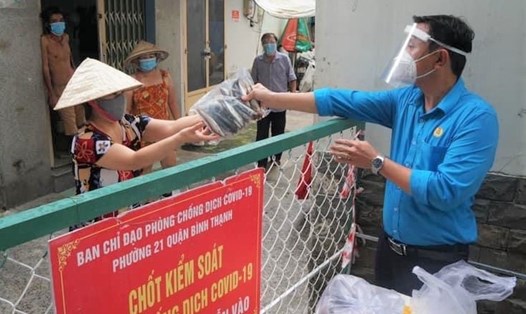 Đại diện LĐLĐ Quận Bình Thạnh, TPHCM trao tặng cá tươi cho người lao động ở khu cách ly, phong tỏa. Ảnh: Đức Long