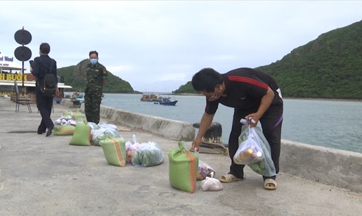 Ngư dân Côn Đảo tự nhận phần quà hỗ trợ trên cầu cảng. Ảnh: MC