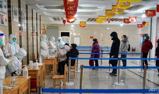 Nhân viên y tế lấy mẫu xét nghiệm COVID-19 tại một tòa nhà văn phòng ở thành phố Cáp Nhĩ Tân, tỉnh Hắc Long Giang, Trung Quốc. Ảnh: AFP