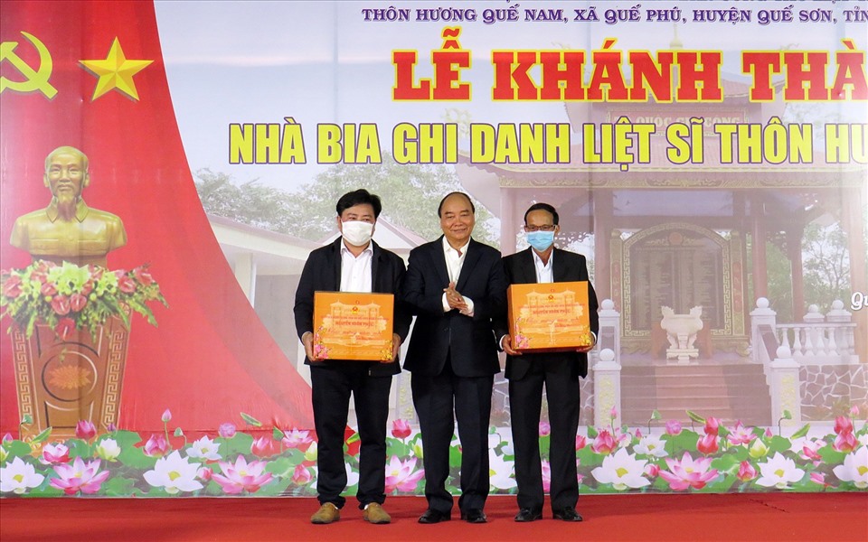 Chủ tịch nước Nguyễn Xuân Phúc tặng quà cho các gia đình liệt sĩ ở thôn Hương Quế Nam. Ảnh: Thanh Chung