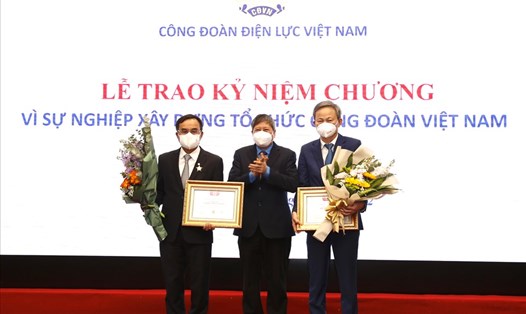 Phó Chủ tịch Thường trực Tổng LĐLĐVN Trần Thanh Hải (giữa) trao Kỷ niệm chương "Vì sự nghiệp xây dựng tổ chức Công đoàn Việt Nam" cho 2 lãnh đạo Tập đoàn EVN. Ảnh: Hà Anh