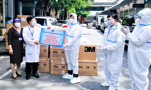 Ông Lê Văn Minh (giữa) cùng đại diện EVNHCMC trao tặng Bệnh viện Nhân dân 115 các trang, thiết bị y tế thiết yếu phòng, chống dịch COVID-19 do CNVCLĐ của EVNHCMC đóng góp một ngày lương để mua. Ảnh: Nam Dương