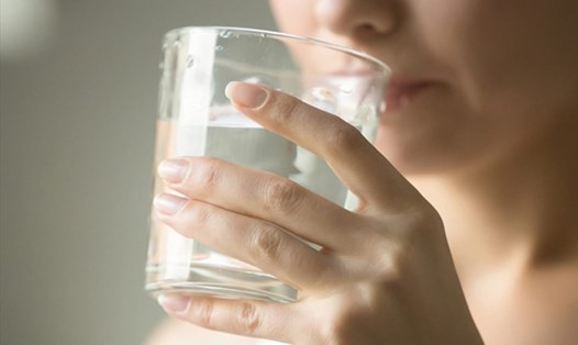 Uống đủ nước sẽ giúp cải thiện tình trạng làn môi khô. Ảnh: Xinhua