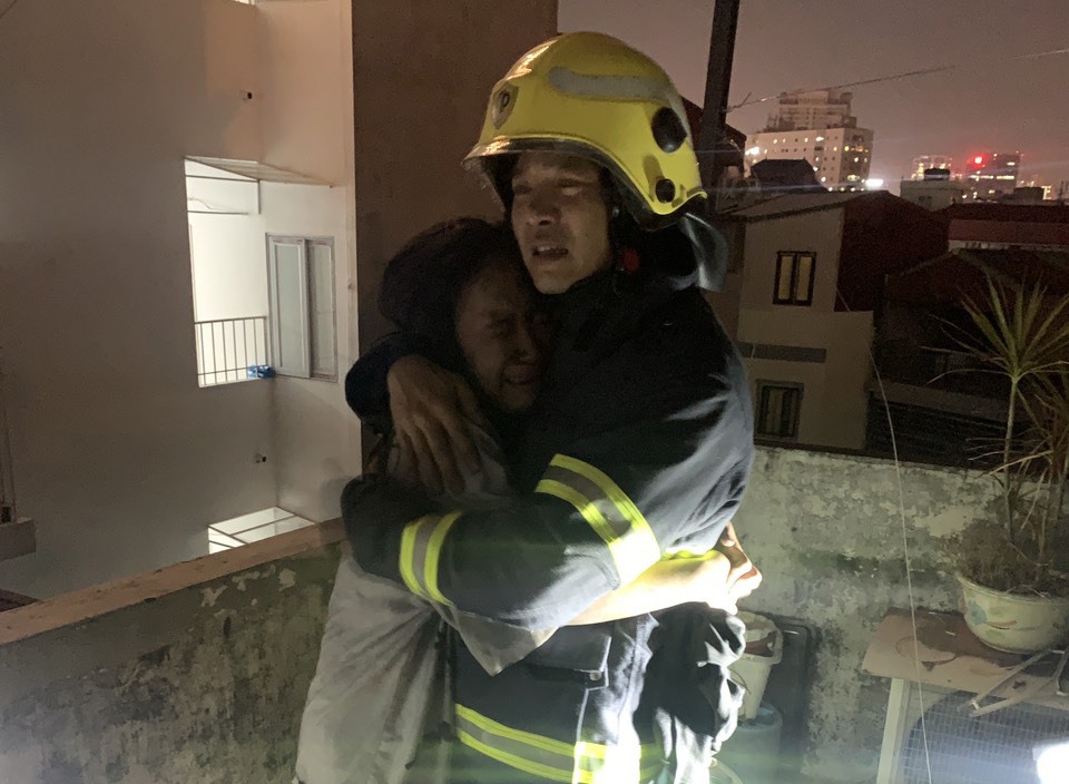 Hình ảnh xúc động giữa lính cứu hoả với người dân sau khi được giải cứu khỏi đám cháy. Ảnh: H.Dũng