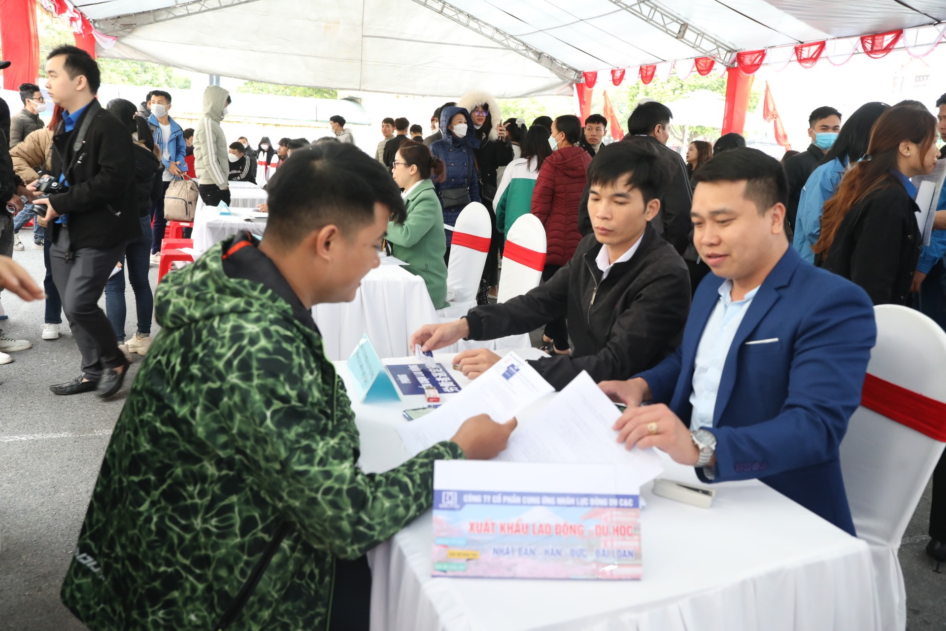 Các nhà tuyển dụng tư vấn, hỗ trợ người lao động tìm hiểu về thị trường xuất khẩu lao động tại các phiên giao dịch việc làm do Trung tâm dịch vụ việc làm tỉnh Ninh Bình tổ chức. Ảnh: NT