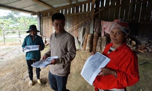 Người dân miền núi huyện Kon Plông nhận các tờ rơi về phòng chống động đất. Ảnh T.T