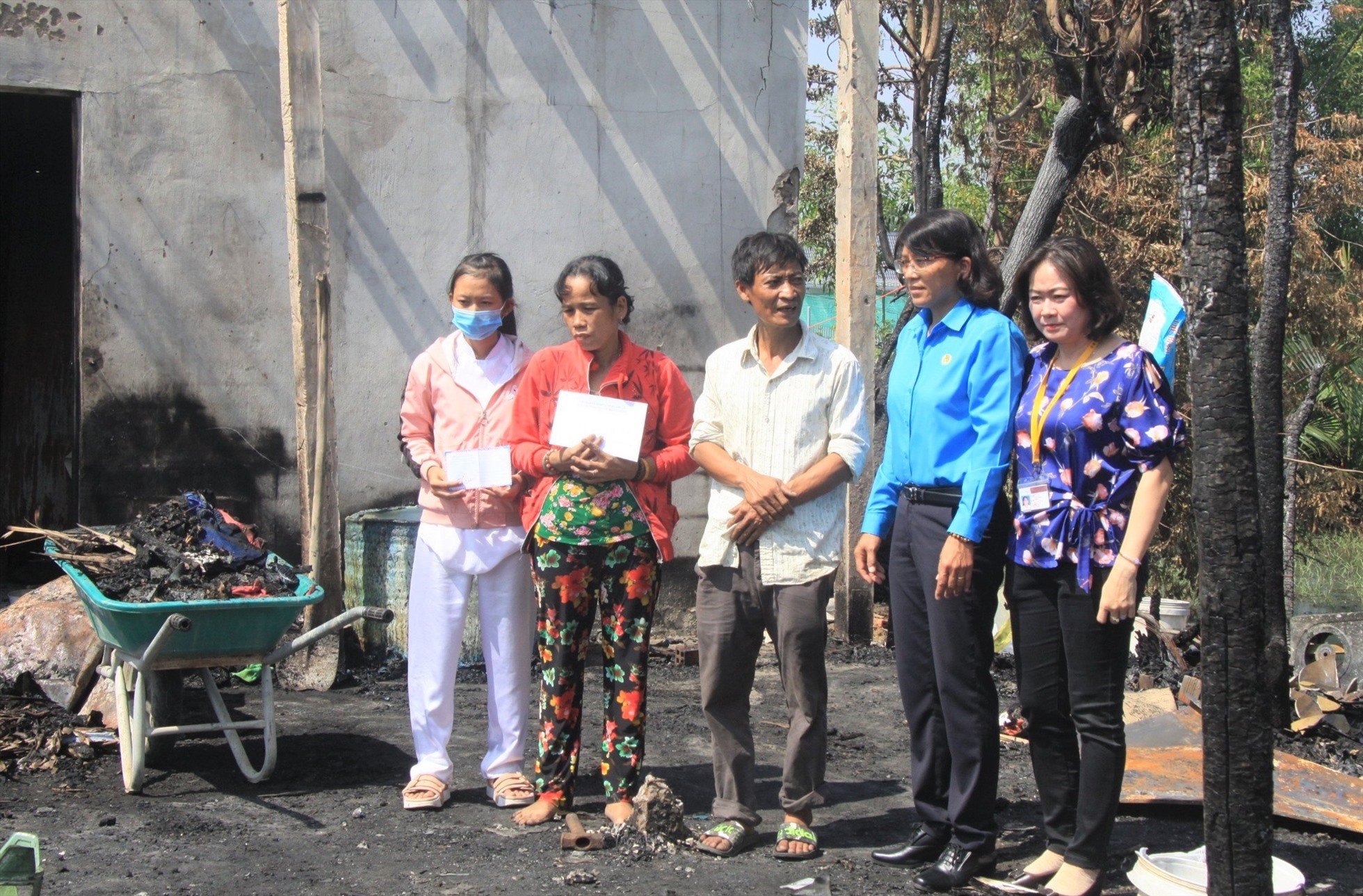 Phó Chủ tịch Liên đoàn Lao động tỉnh Long An Lê Thị Thu Cúc (đứng thứ 2, phải qua) trao hỗ trợ và động viên gia đình chị Yến Mai. Ảnh: LĐLĐ tỉnh Long An. Ảnh: Thành Nhân